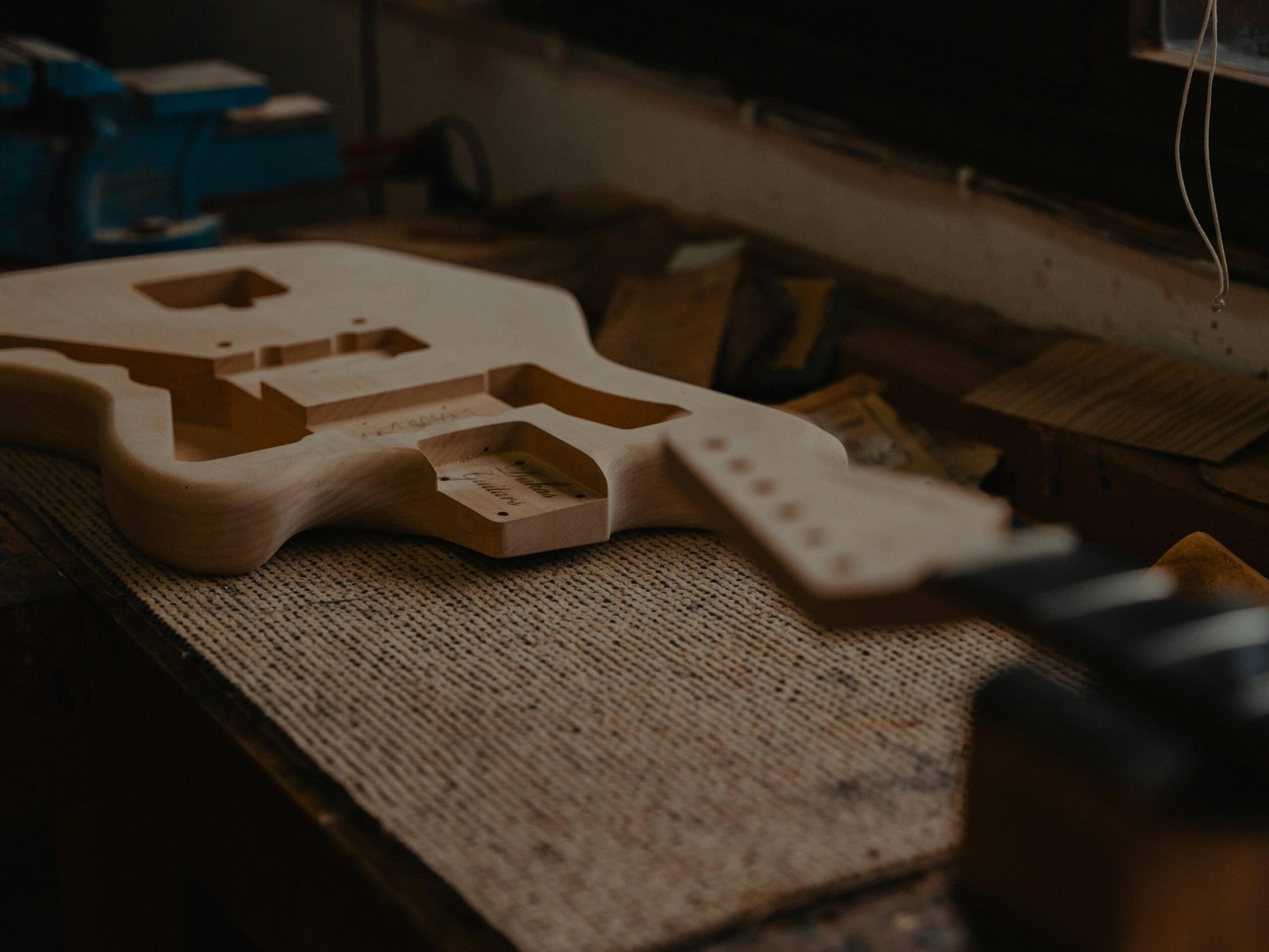 Handcrafted wooden DIY guitar stand holding an acoustic guitar.