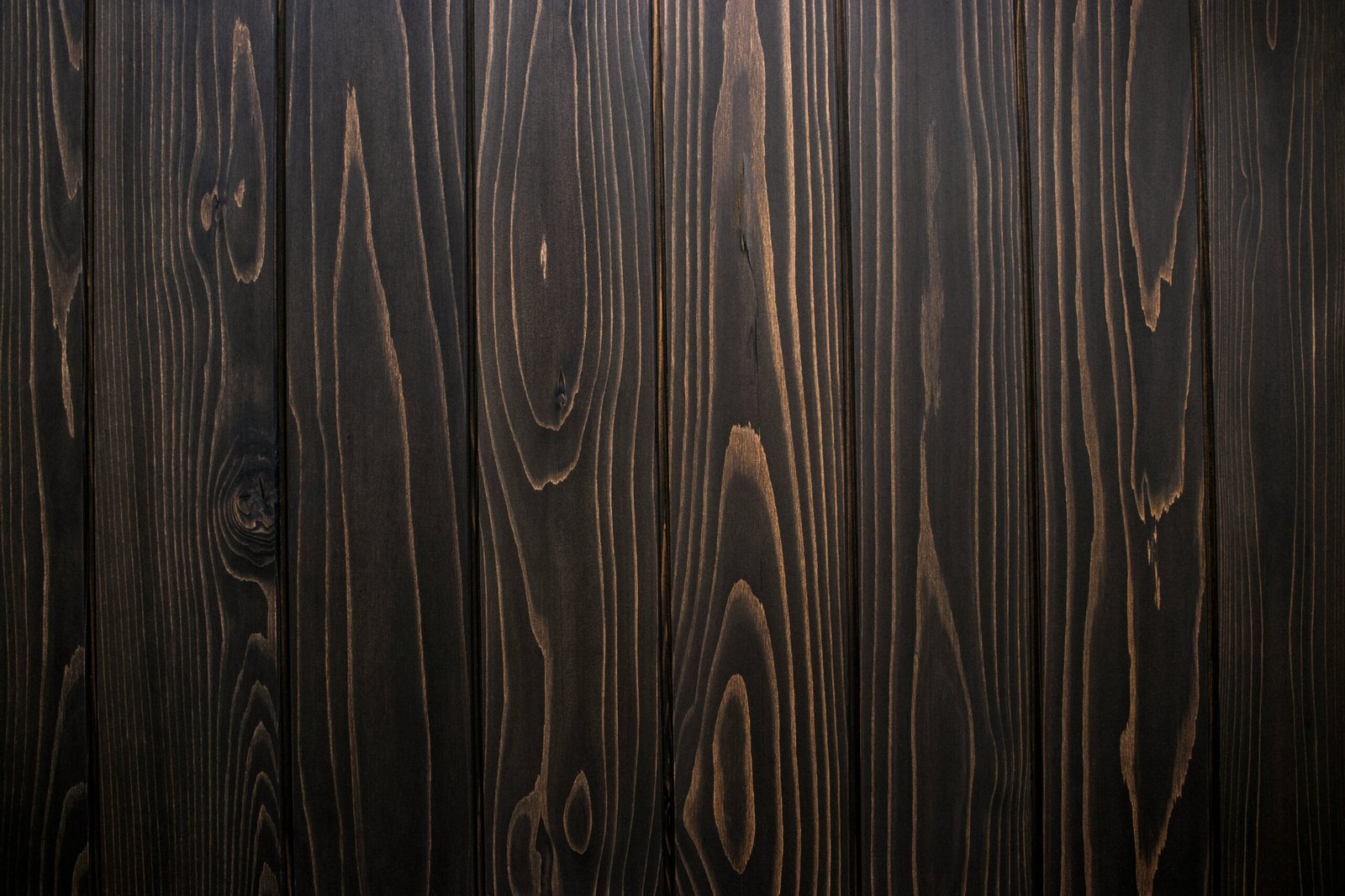 Close-up of ebonized wood with a deep black finish.